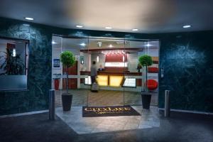 a lobby with two potted plants in a building at CityLife Wellington in Wellington