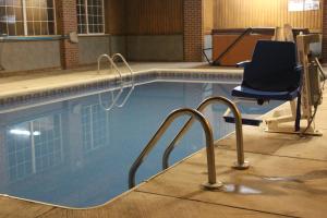 a swimming pool with a chair sitting next to it at Garden City Inn in Garden City