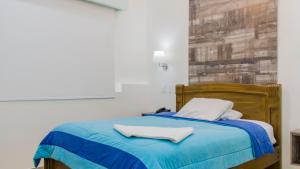 Postel nebo postele na pokoji v ubytování Hotel Ciudad Latin Palace
