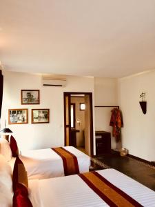Giường trong phòng chung tại Khmer Paradise Villa