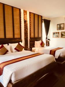 Giường trong phòng chung tại Khmer Paradise Villa