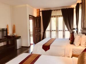 Giường trong phòng chung tại Khmer Paradise Villa
