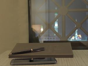 a pen sitting on top of a notebook on a table at Le Bosphorus Hotel - Waqf Safi in Al Madinah