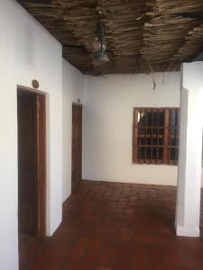 an empty room with a white wall and a window at LA CHOZA in Mompos
