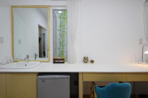 a bathroom with a sink and a mirror at Babylon D3 Serviced Apartment in Ho Chi Minh City