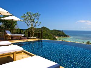a swimming pool with a view of the ocean at Chintakiri Resort in Koh Tao