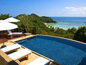 a swimming pool with a view of the ocean at Chintakiri Resort in Ko Tao