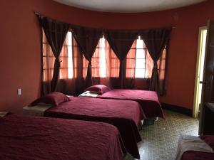 A bed or beds in a room at Hotel Mayesstic