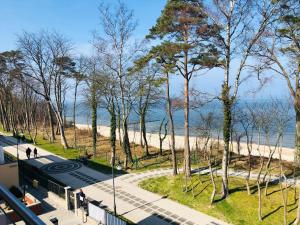 a view of the beach from the balcony of a building at APARTAMENT ELEGANCE YELLOW in Rewal
