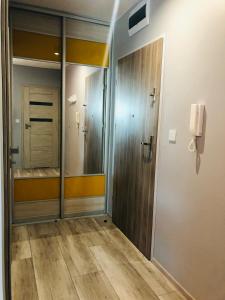 a hallway with a door and a phone on a wall at APARTAMENT ELEGANCE YELLOW in Rewal +27 photos