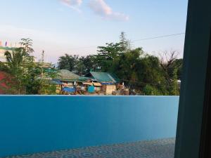 a blue fence with a village in the background at Sephreen Home stay in San Juan