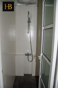 a shower in a bathroom with a glass door at H Benjamin Residence in Kampong Kundassan