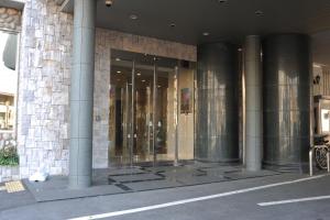 a building with glass doors on the side of it at Suizenji Comfort Hotel in Kumamoto