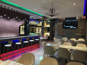a restaurant with tables and chairs and a bar at Qu Lin Resident in Sibu