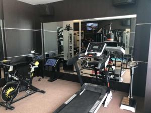 a room with a gym with a treadmill and other equipment at Qu Lin Resident in Sibu