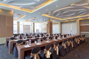 a conference room with long tables and chairs at favehotel Solo Baru in Solo