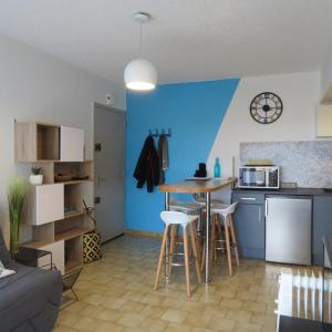 a kitchen with a table and chairs in a room at appartement 4 pers 50 m plage 4B237 in Le Barcarès