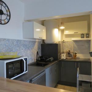 a kitchen with a microwave and a counter top at appartement 4 pers 50 m plage 4B237 in Le Barcarès