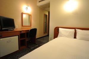 En eller flere senge i et værelse på Suizenji Comfort Hotel