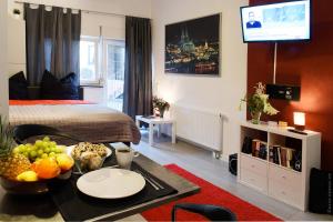 a room with a bed and a table with fruit on it at Haus Gronau in Bergisch Gladbach