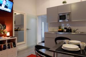 a kitchen with a table with chairs and a microwave at Haus Gronau in Bergisch Gladbach