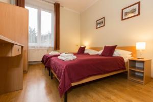 Posteľ alebo postele v izbe v ubytovaní Mały Kraków Aparthotel