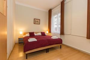 Posteľ alebo postele v izbe v ubytovaní Mały Kraków Aparthotel