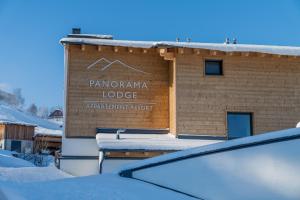 a sign on the side of a brick building at Panorama Lodge Premium Apartments in Schladming