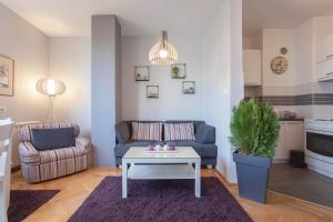 a living room with a couch and a table at VIOLET APARTMENT in Skopje