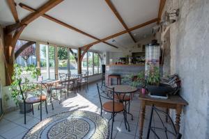 a restaurant with tables and chairs in a room at Logis Hôtels - Hôtel et Restaurant Les Voyageurs in Tournon-dʼAgenais