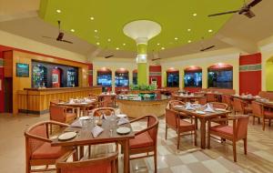 a dining room with tables and chairs in a restaurant at The Fern Kesarval Hotel & Spa, Verna Plateau - Goa in Verna