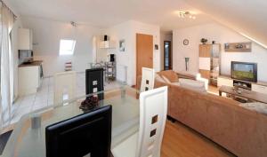 a living room with a glass table and a couch at Haus Gerrie in Mauth