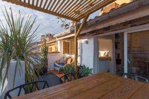 a wooden table on a balcony with plants at Ze Perfect Place - Vieux Nice - Exceptionnel Appartement - Calme et Terrasse avec vues in Nice