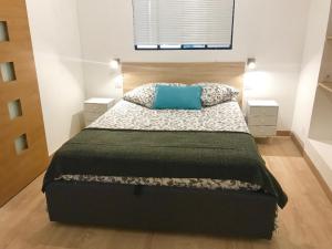 a bedroom with a bed with a blue pillow on it at Petit Jean in Saint-Tropez