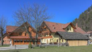 une grande maison avec une clôture devant elle dans l'établissement Farm Holidays Povsin, à Bled