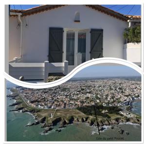 a white house with a view of a city at Gîte du Petit Poucet in Saint-Hilaire-de-Riez