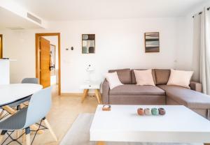 a living room with a couch and a table at Apartment La Loma Mar Menor Golf Resort in Los Martínez