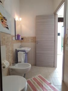 a bathroom with a toilet and a sink at agriturismo heaven in Capo Vaticano