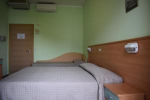 Postel nebo postele na pokoji v ubytování Hotel Martinez
