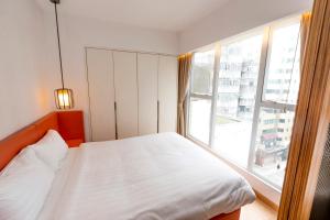 Uma cama ou camas num quarto em Homy Residence