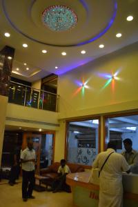 a group of people in a lobby with a ceiling at Hotel Susee Park in Tiruchchirāppalli
