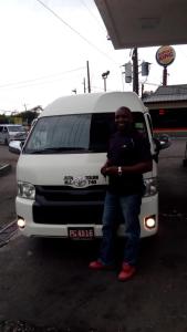 a man standing in front of a white van at Cazwin Villas in Montego Bay