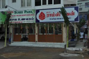a store with signs on the front of a building at Hotel Susee Park in Tiruchchirāppalli
