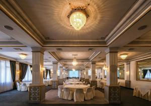 a banquet hall with tables and a chandelier at Majestic Hotel in Tunis
