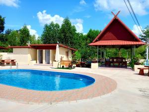 a swimming pool in a yard with a gazebo at Private 2 bedroom villa with Swimming pool Tropical gardens Fast Wifi smart Tv in Ban Sang Luang