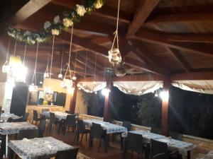 a dining room with tables and chairs and lights at Residence e B&B La Cappella Del Convento in Rodi Garganico