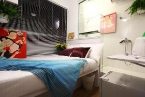 um quarto com uma cama, uma janela e um lavatório em Apple lnn Causeway Bay em Hong Kong