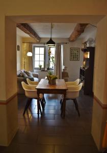 a living room with a table and yellow chairs at A L’Abri Du Loup in Roquefort-sur-Garonne