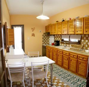 a kitchen with a white table and chairs in it at Villa Christie in Keramoti