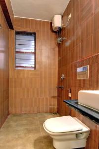 a bathroom with a toilet and a sink at Candolim Serviced Apartments in Candolim
